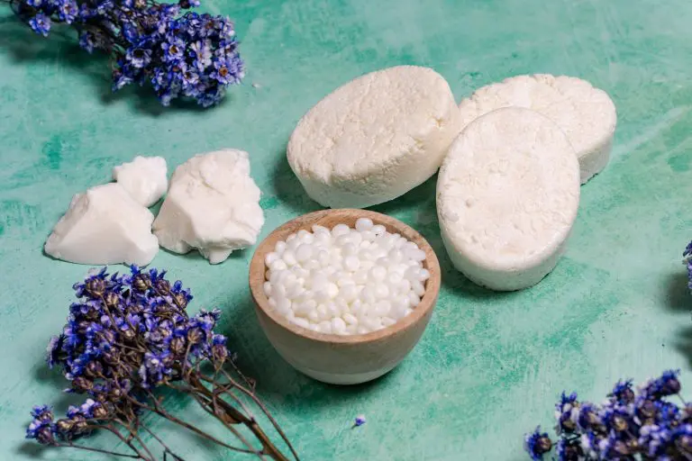 Shampoo bars, shea butter and lavender on green background