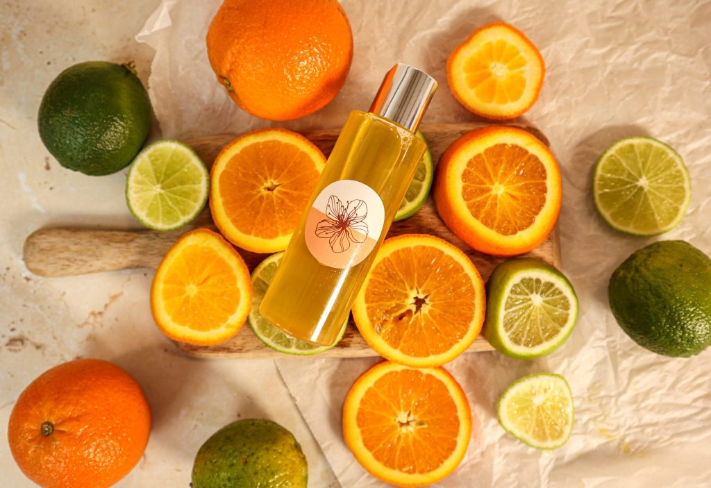 Citrus fruits with citrus-scented oil bottle