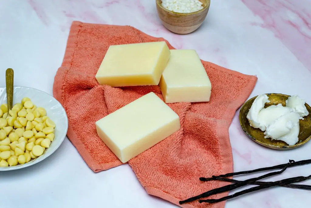 Natural conditioner bars with ingredients on towel